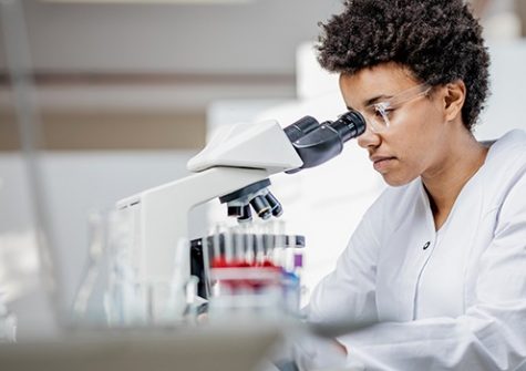 Young Scientist Working With The Microscope