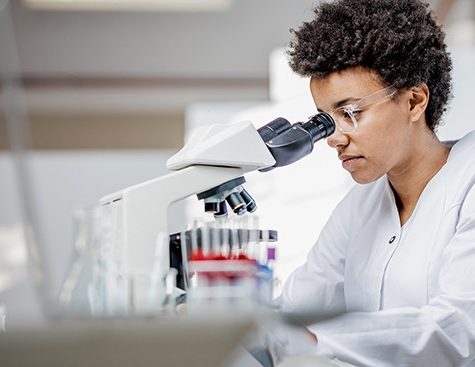 Young Scientist Working With The Microscope